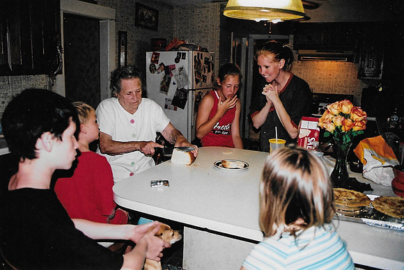 Grandma cutting bread