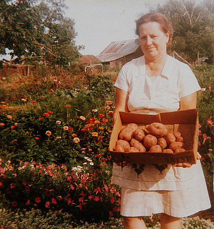 Grandma showing her homegrown potatoes