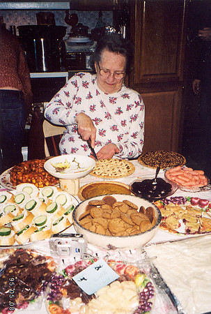 Grandma cutting a pie for another feast 2005